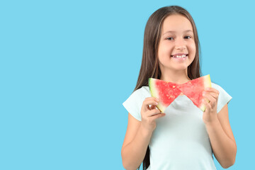 Wall Mural - Happy little girl with slices of fresh watermelon on blue background