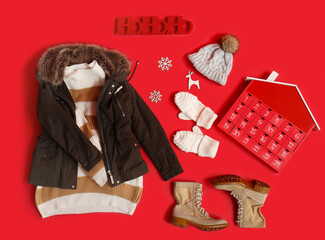 Wall Mural - Composition with stylish warm clothes, shoes and winter advent calendar on red background