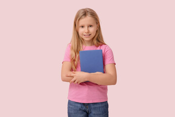 Poster - Cute little girl with book on pink background