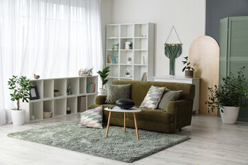 Canvas Print - Interior of living room with green sofa and glucophone on table