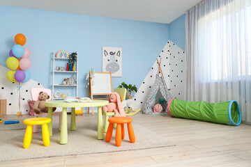 Poster - Interior of modern playroom in kindergarten with table, chairs and toys