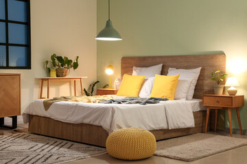 Wall Mural - Interior of bedroom with comfortable bed, pouf and glowing lamps