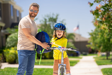 Sticker - Fathers day. Father and son riding a bike on the road at the fathers day. Concept of friendly family. Parents and children being friends. Father and son riding a bike outdoor. Child first bike.