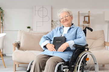 Wall Mural - Senior woman in wheelchair with Bible at home