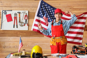 Wall Mural - Female Asian worker with USA flag in workshop. Labour Day celebration