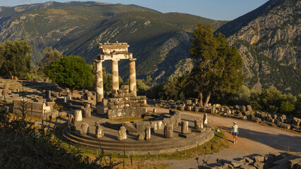 Wall Mural - Man walking among ancient ruins in Delphi, Greece