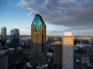 The urban skyline looks stunning with a glass tower during the bustling downtown sunset