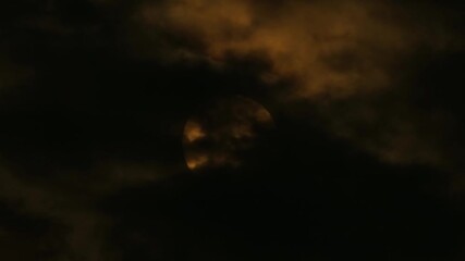 Wall Mural - a full moon emerging majestically through the dark night clouds - timelapse