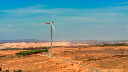 Wall Mural - windmill park with clouds and a blue sky, wind mill turbines in the ocean aerial view of a wind farm