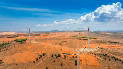 Wall Mural - windmill park with clouds and a blue sky, wind mill turbines in the ocean aerial view of a wind farm