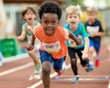 © porpia - Energetic kids competing in a track race, showcasing determination, teamwork, and the spirit of competition at a sports event.