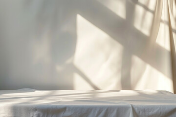 Poster - A white tablecloth with a white wall in the background. The tablecloth is folded and placed on a table