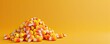 © PinkPearly - 3D candy corn pile on a vivid yellow background, left side blank space for marketing