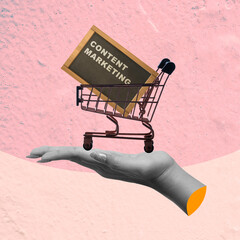 Wall Mural - A human hand holding a shopping cart carrying a board with content marketing text