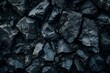 © Sourav Mittal - Black rock texture background, close-up of dark black rocks with light shadow and natural lighting. Black rock surface pattern with detailed shadows for design or text backdrop. The photo was taken on