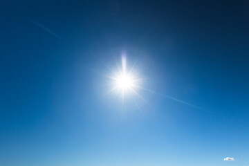 Wall Mural - deep blue sky with glowing sun, natural background photo