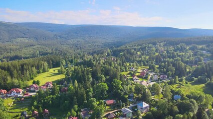 Canvas Print - Aerial view of a village in the mountains forest of Germany on a sunny day