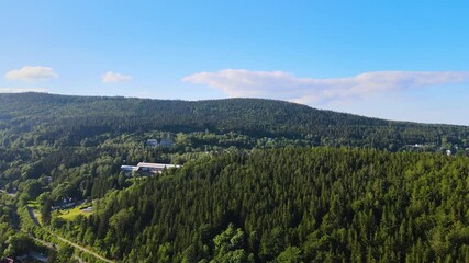 Canvas Print - Aerial view of a village in the mountains forest of Germany on a sunny day