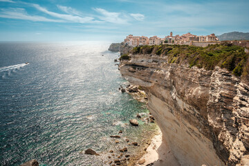 Wall Mural - The citadel of Bonifacio in Corsica where houses are perched above the Mediterranean sea on limestone cliffs which have been undercut by the sea and weather