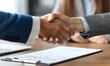 © Pumapala - Business Handshake over Signed Document