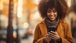 © tetxu - happy beautiful African American woman texting on smartphone on street