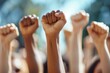 © Ольга Лукьяненко - Multi ethnic people raising their fists up in the air. ai generative