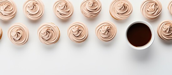 Leinwandbilder - View from above of chocolate meringue cookies and a cup of coffee on a white surface with a blank area for adding text or images. with copy space image. Place for adding text or design