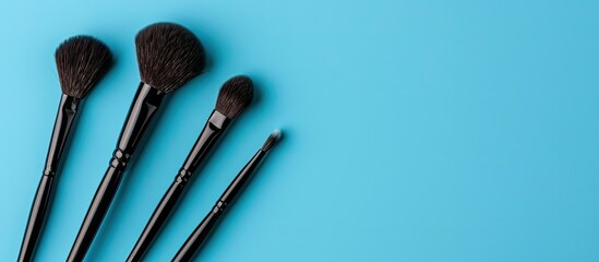 Poster - Makeup brushes for eyeshadow on a blue backdrop with copy space image.