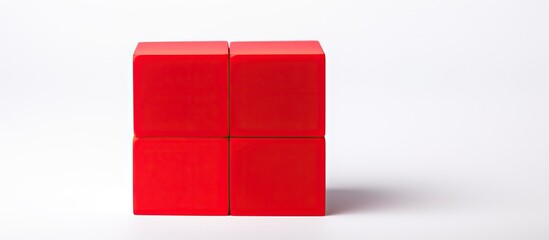 Poster - Close-up view of a red building block against a white backdrop with ample copy space image.