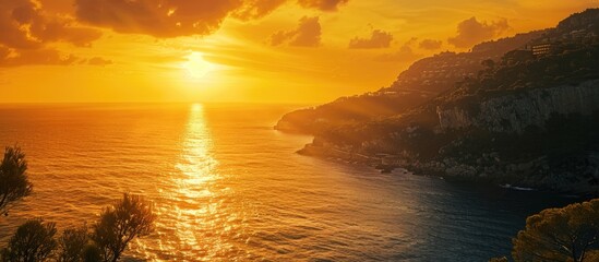 Fototapete - Beautiful golden sunset over the sparkling Mediterranean sea with a breathtaking view in a copy space image.