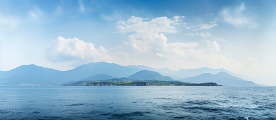 Aufkleber - Panoramic south landscape with a soft focus, featuring a vivid blue sea in the foreground and a distant mountain ridge on the horizon, perfect for a wallpaper with copy space image.