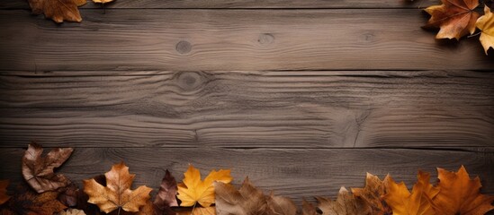 Poster - Autumn-themed decorations featuring wooden boards, dry leaves, and a brown paper backdrop, creating a rustic atmosphere with a copy space image.