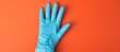© vxnaghiyev - Top view of an inflated medical glove against a colored background, with a designated area for text in the image. with copy space image. Place for adding text or design