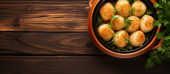 Aufkleber - Top view of potato dumplings fried in a clay pot on a wooden background with copy space image.