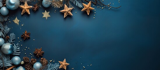 Poster - Top view of Christmas-themed flat lay featuring tree branches, cones, vintage stars on a blue background, ideal as a Xmas banner mockup or greeting card template with copy space image.