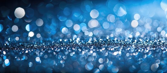 Poster - Abstract festive header with sparkling silver glitter on a blue background, creating a shimmering holiday ambiance with wide panoramic copy space image for design.
