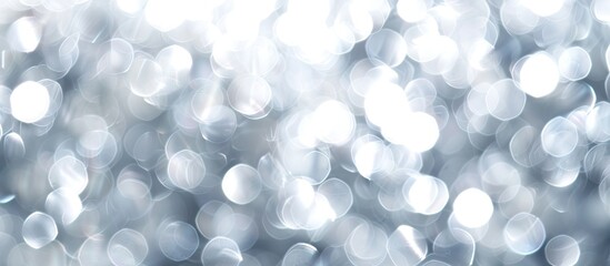Poster - Abstract white and silver bokeh lights in soft focus, perfect as a background with copy space image.