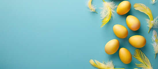 Sticker - Yellow Easter eggs with feather decorations on a soft blue background for a top view flat lay image with space for text. copy space available