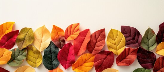 Sticker - Background in autumn shades featuring colorful felt leaves for a copy space image.