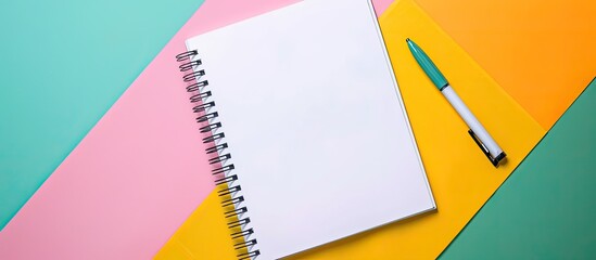Poster - blank notebook with spiral binding open on a colorful desk background, displaying a top view with sp