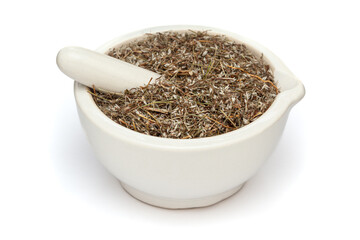 Close-up of Dry Organic Pitpapra or Varatika (Fumaria Indica) herb, in white ceramic mortar and pestle, isolated on a white background.