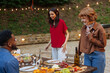 © bernardbodo - Friends enjoying an outdoor dinner party