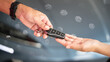 © Nattawit - Action of human hands are giving and taking a car key. Buying the new car or car rental business concept scene, Close-up and selective focus at the object.