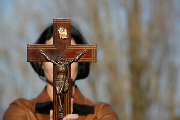 Sticker - Woman with a crucifix of Jesus.  Religious fervor.