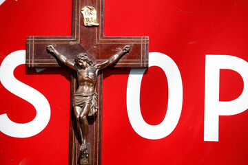 Crucifix and stop sign. Anti-religious concept France.