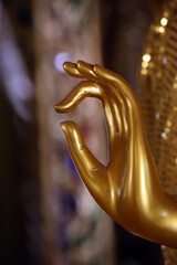 Poster -  Wat Si Muang ( Simuong) buddhist temple.  Golden Buddha statue. Close-up of a hand doing a mudra.  Vientiane. Laos;