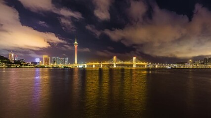 Wall Mural - Beautiful coastline and modern city buildings scenery at night in Macau. Famous travel destination.