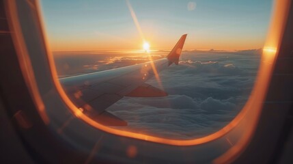 Wall Mural - Sunset view from plane window, with wing and clouds