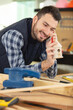 © auremar - happy young carpenter talking on the phone