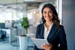 © id512 - Confident Mixed-Race Businesswoman Holding Digital Tablet in Modern Office